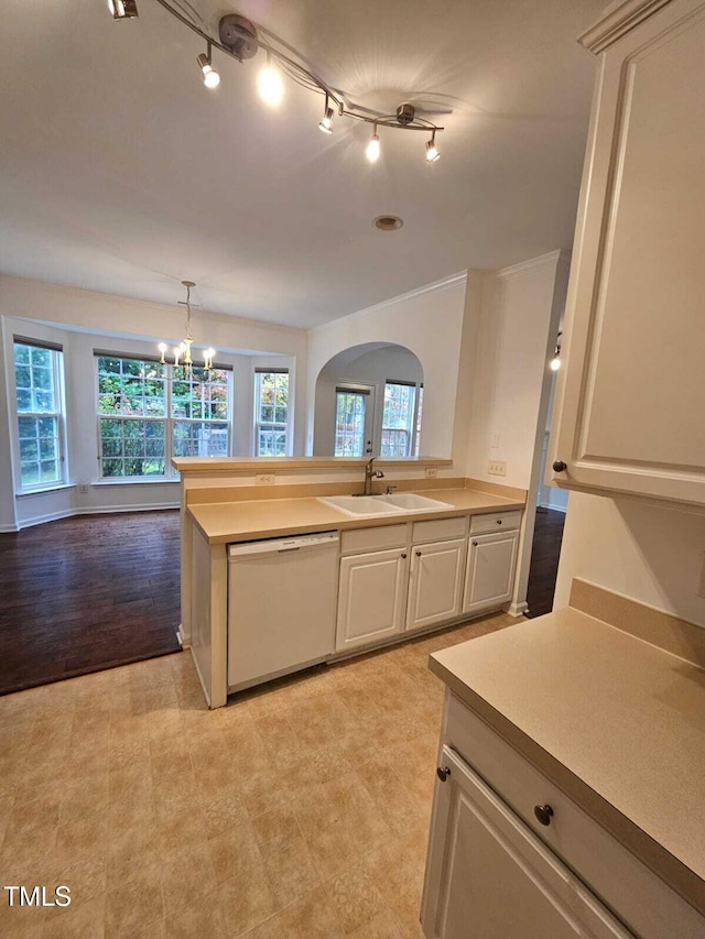 kitchen with an inviting chandelier, white dishwasher, sink, hanging light fixtures, and light wood-type flooring