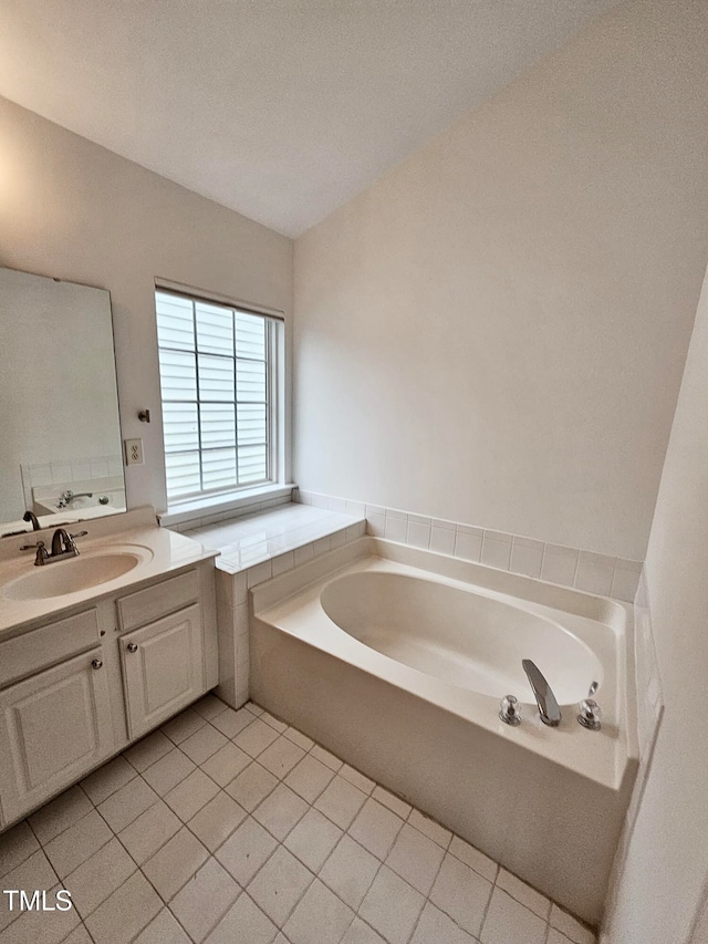 bathroom featuring a bathing tub, tile patterned flooring, vanity, and a textured ceiling