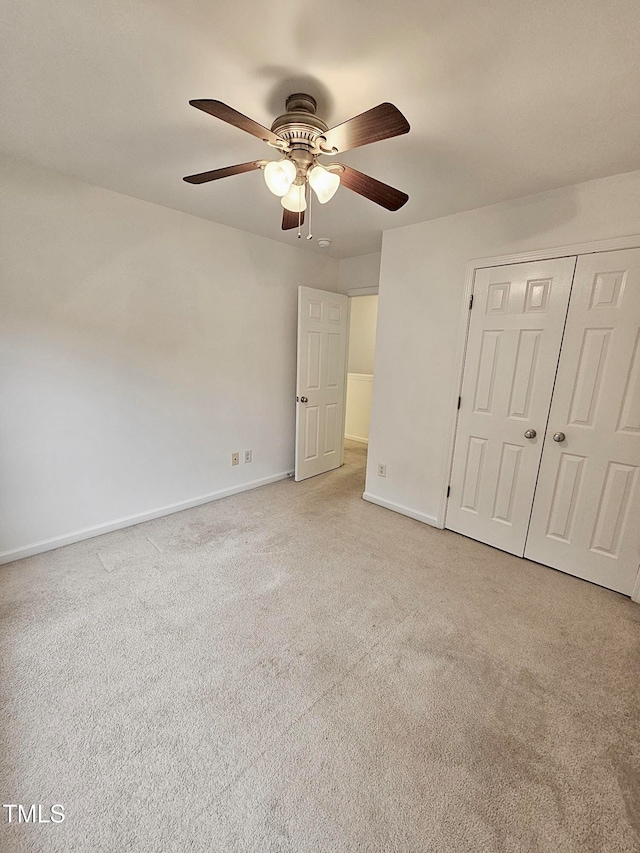 unfurnished bedroom with a closet, ceiling fan, and light colored carpet