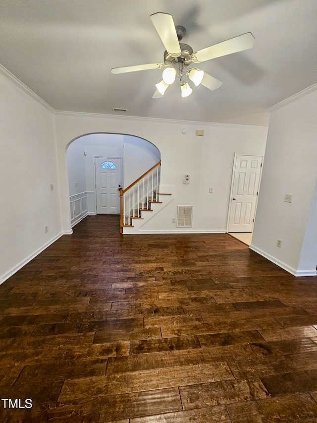 unfurnished living room with dark hardwood / wood-style flooring, ceiling fan, and ornamental molding