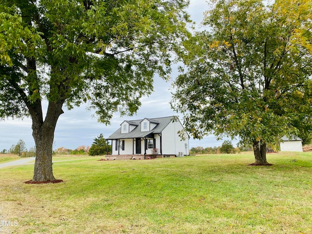 cape cod home with covered porch and a front yard