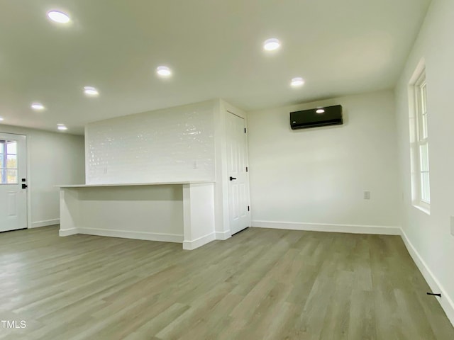 interior space featuring light hardwood / wood-style floors and a wall unit AC