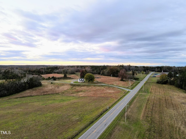 aerial view at dusk featuring a rural view