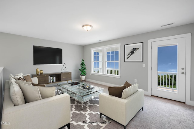 living room featuring carpet floors and plenty of natural light