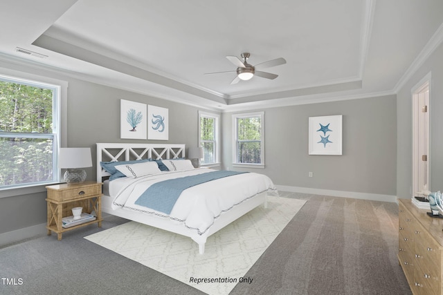 bedroom featuring carpet, crown molding, a raised ceiling, and ceiling fan