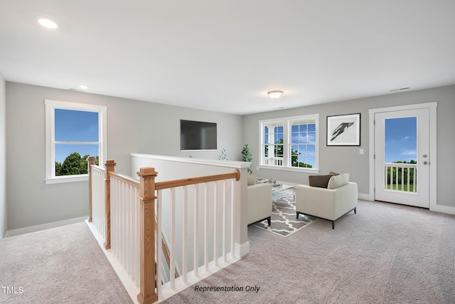 carpeted living room with a healthy amount of sunlight