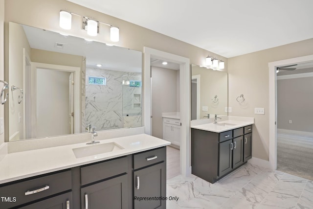 bathroom with vanity and tiled shower