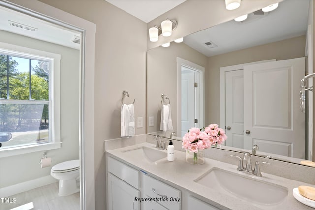 bathroom with vanity, toilet, and tile patterned flooring