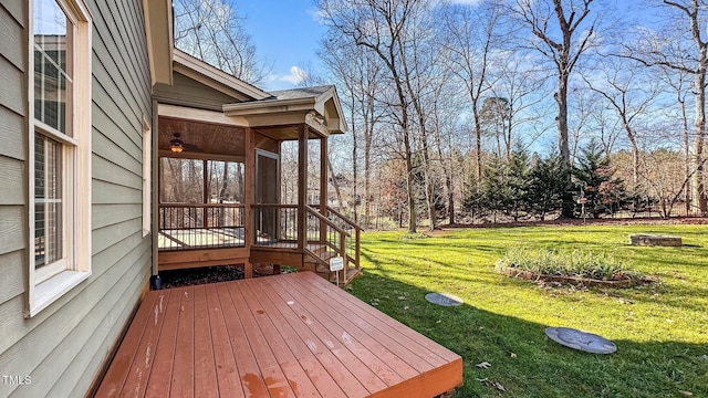 wooden terrace featuring a sunroom and a yard