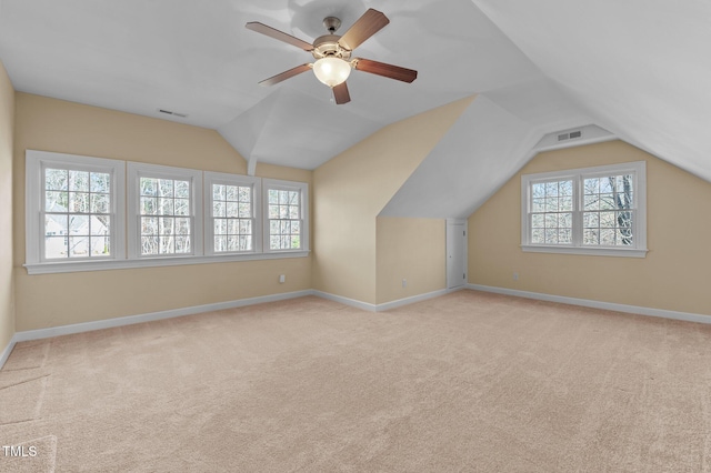 bonus room with ceiling fan, light colored carpet, and vaulted ceiling