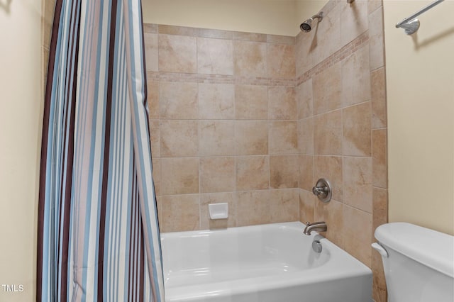 bathroom featuring shower / bath combo and toilet