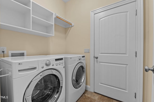 laundry area with tile patterned floors and washing machine and clothes dryer