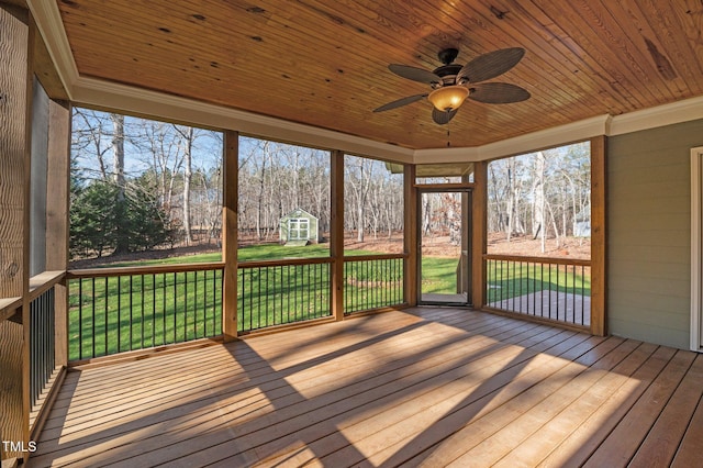 unfurnished sunroom with ceiling fan and wooden ceiling