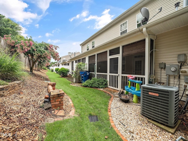 view of yard featuring central AC and a sunroom