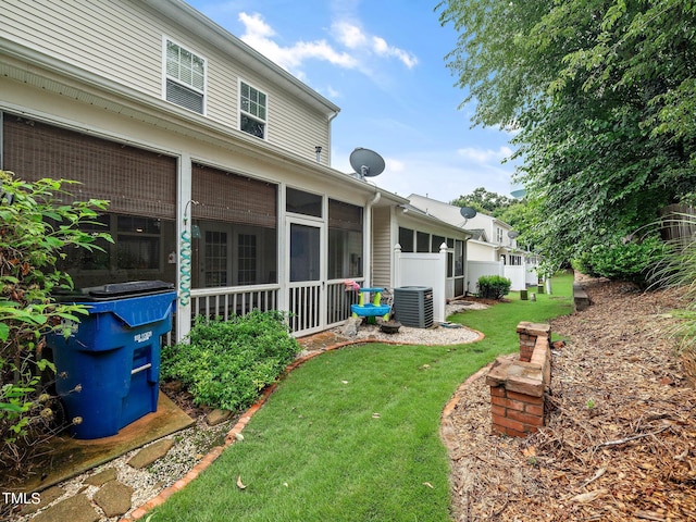 view of yard featuring a sunroom and cooling unit