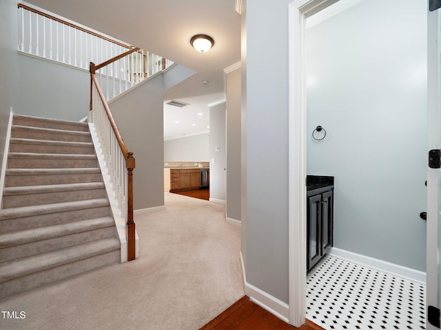 interior space with carpet, lofted ceiling, and ornamental molding