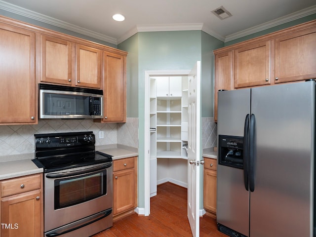 kitchen featuring decorative backsplash, crown molding, light hardwood / wood-style floors, and appliances with stainless steel finishes