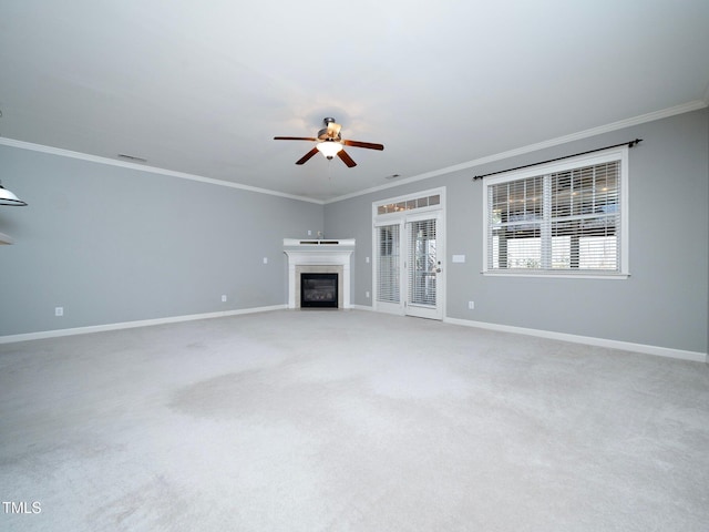 unfurnished living room featuring crown molding, carpet floors, and ceiling fan