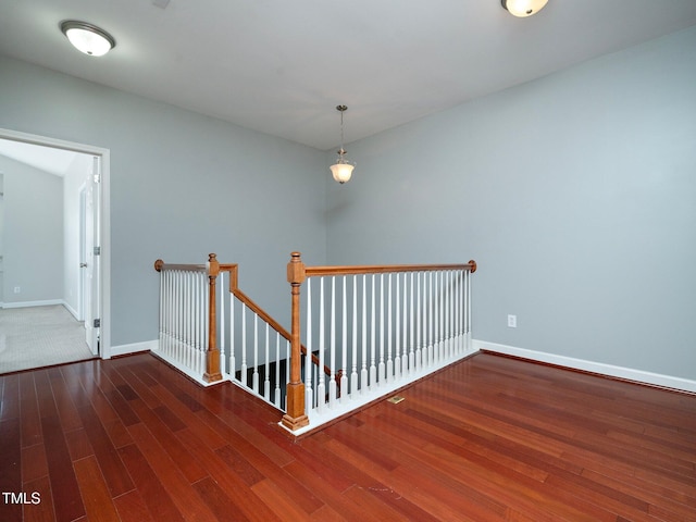 stairs featuring hardwood / wood-style floors