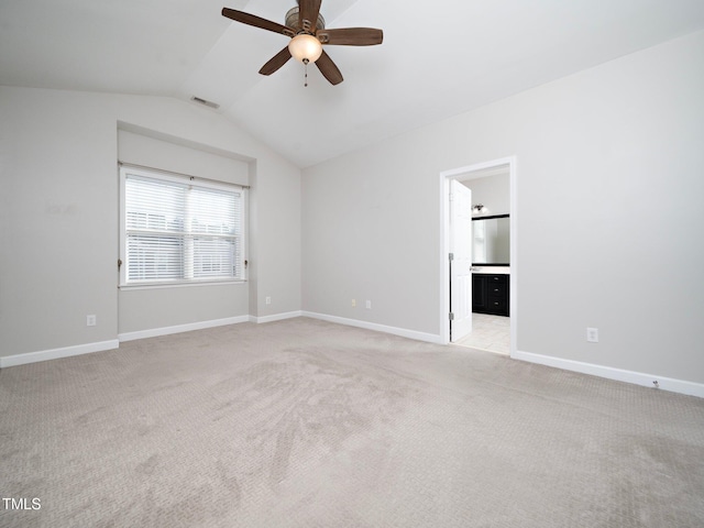 interior space with ceiling fan, lofted ceiling, and light carpet