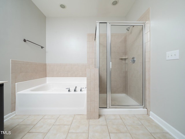 bathroom featuring tile patterned flooring and independent shower and bath