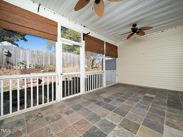 unfurnished sunroom featuring wooden ceiling and track lighting