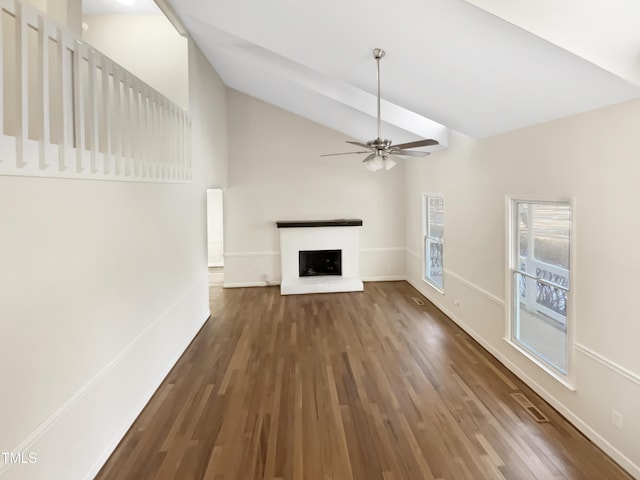 unfurnished living room with dark wood-type flooring, ceiling fan, and vaulted ceiling