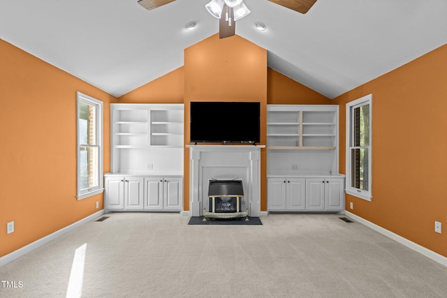 unfurnished living room featuring lofted ceiling, light carpet, and ceiling fan