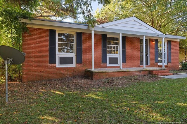 view of home's exterior featuring a porch and a lawn