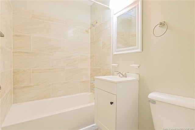 full bathroom featuring vanity, tiled shower / bath combo, and toilet