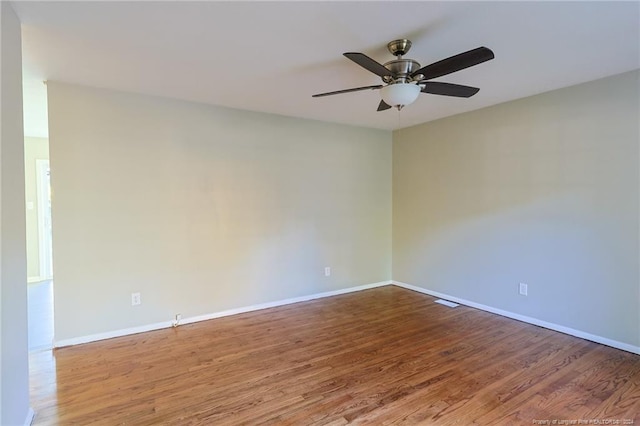 empty room featuring hardwood / wood-style flooring and ceiling fan