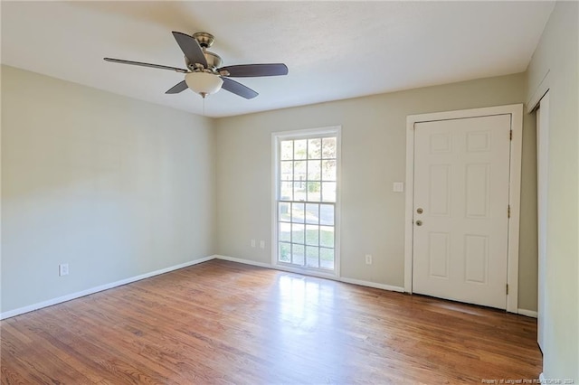 unfurnished room with ceiling fan and wood-type flooring