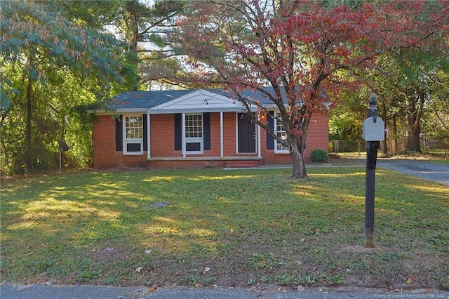 ranch-style home with a front lawn