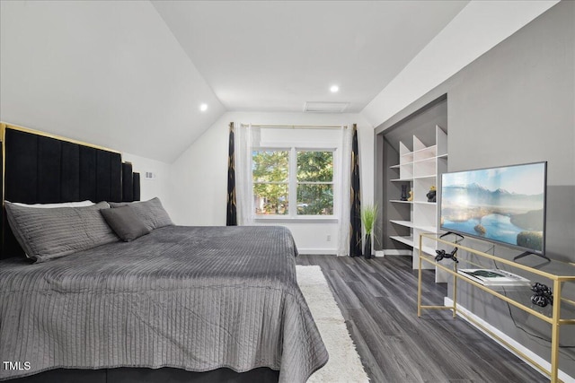 bedroom with dark wood-type flooring and lofted ceiling