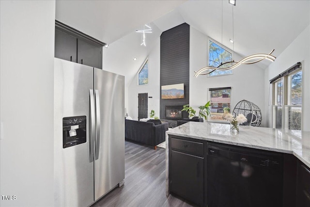 kitchen featuring a fireplace, black dishwasher, dark hardwood / wood-style floors, high vaulted ceiling, and stainless steel refrigerator with ice dispenser