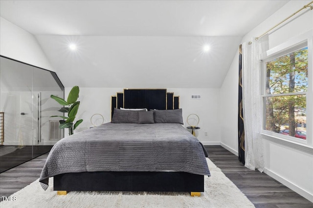 bedroom featuring dark hardwood / wood-style floors and lofted ceiling