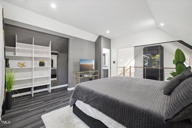 bedroom with dark wood-type flooring, ensuite bath, and vaulted ceiling