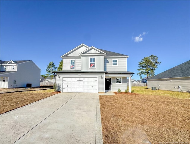 view of front of home with a front yard and a garage