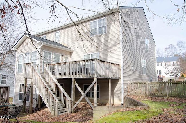 rear view of property featuring a wooden deck