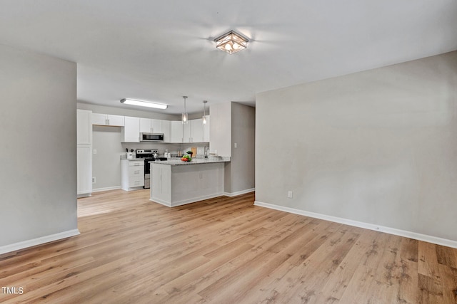 kitchen featuring kitchen peninsula, white cabinets, pendant lighting, light hardwood / wood-style floors, and stainless steel appliances