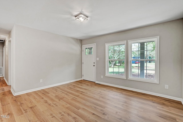 unfurnished room with light wood-type flooring