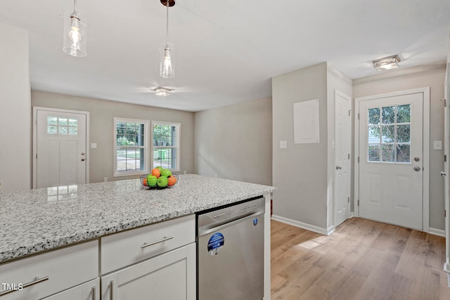 kitchen featuring light hardwood / wood-style floors, a wealth of natural light, stainless steel dishwasher, and white cabinets