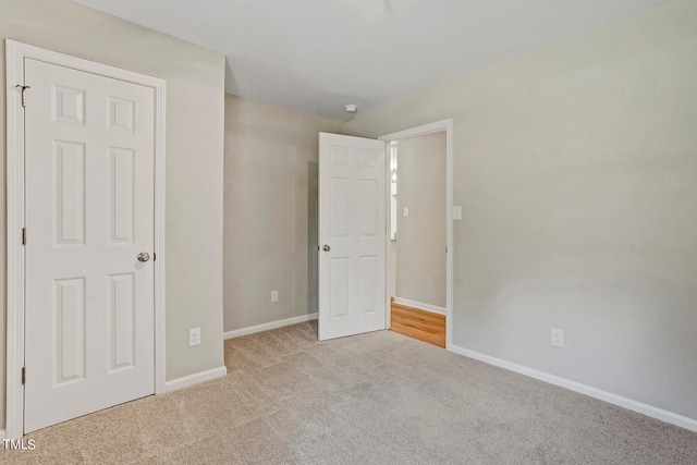 unfurnished bedroom with light colored carpet