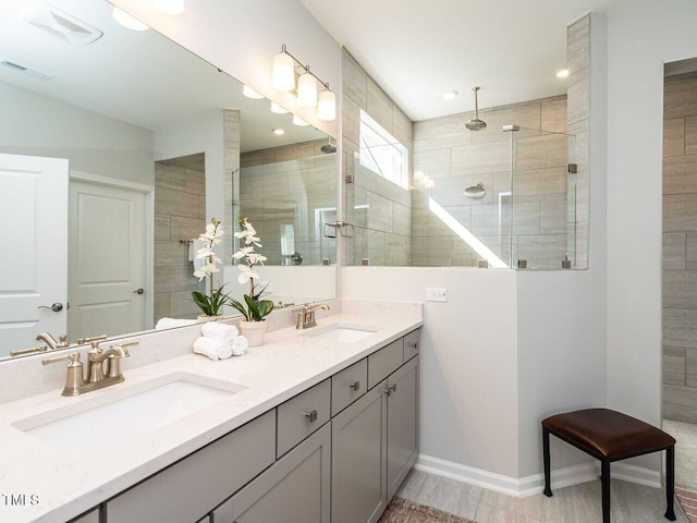 bathroom with vanity and tiled shower