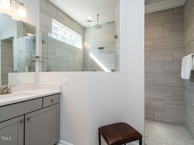 bathroom featuring vanity and tiled shower