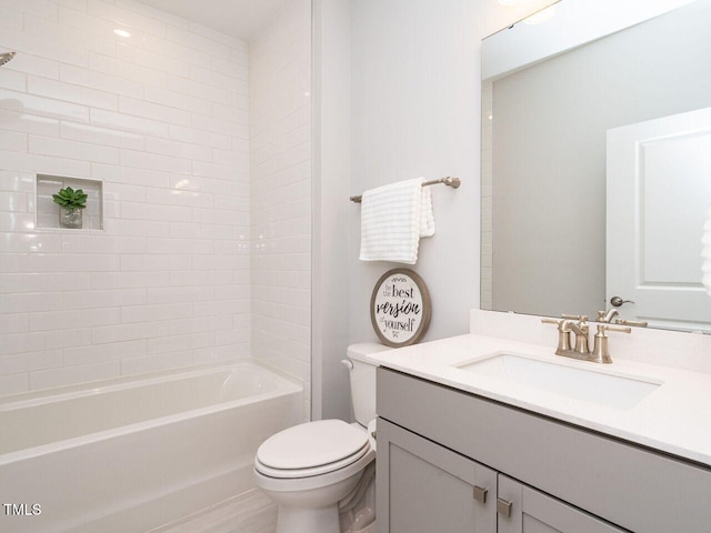 full bathroom featuring vanity, toilet, and tiled shower / bath combo