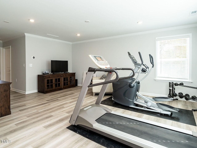 workout area with crown molding and light wood-type flooring