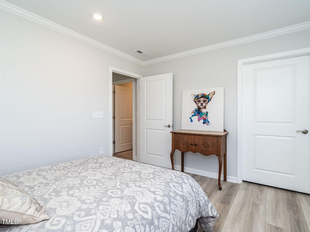 bedroom featuring light hardwood / wood-style flooring and ornamental molding