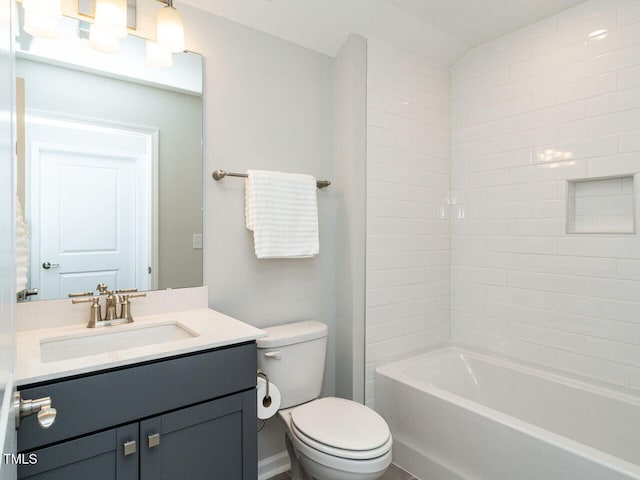 full bathroom with toilet, tiled shower / bath combo, and vanity