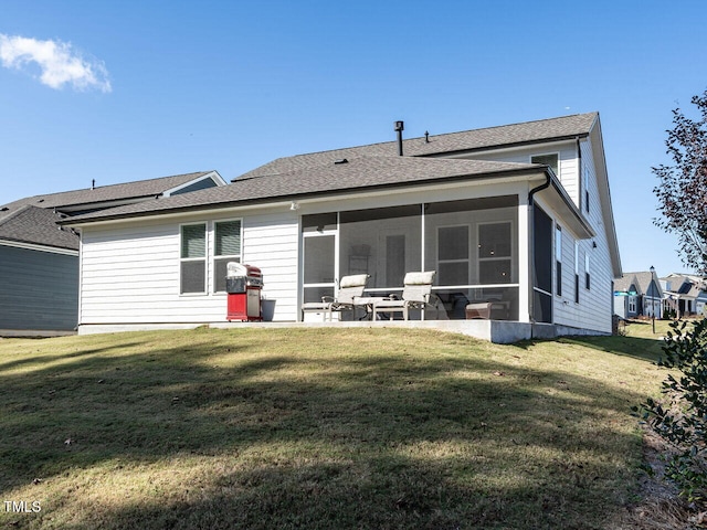 back of property with a patio area, a yard, and a sunroom